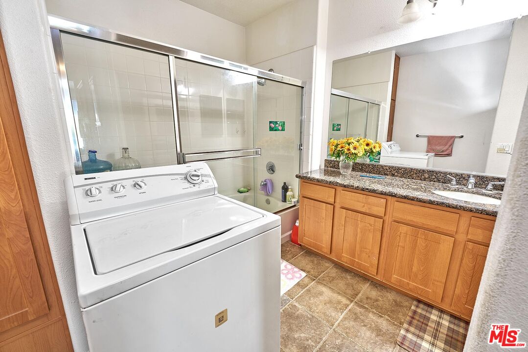12664 Chapman Avenue, Unit 1208 Garden Grove, CA 92840 - Photo 16 of 29 a view of washer and dryer with a mirror