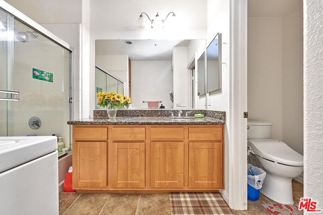 12664 Chapman Avenue, Unit 1208 Garden Grove, CA 92840 - Photo 17 of 29 a bathroom with a sink a toilet and shower