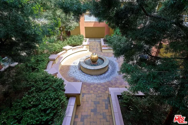 a aerial view of a house with garden space and a patio