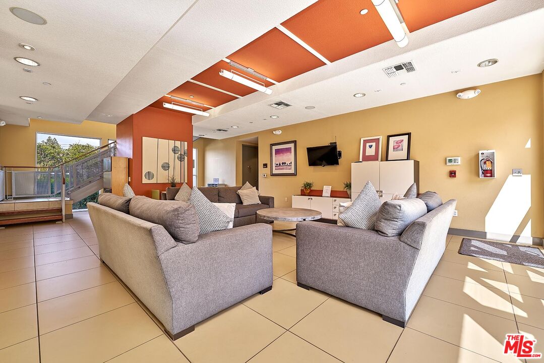 12664 Chapman Avenue, Unit 1208 Garden Grove, CA 92840 - Photo 24 of 29 a living room with furniture and a large window