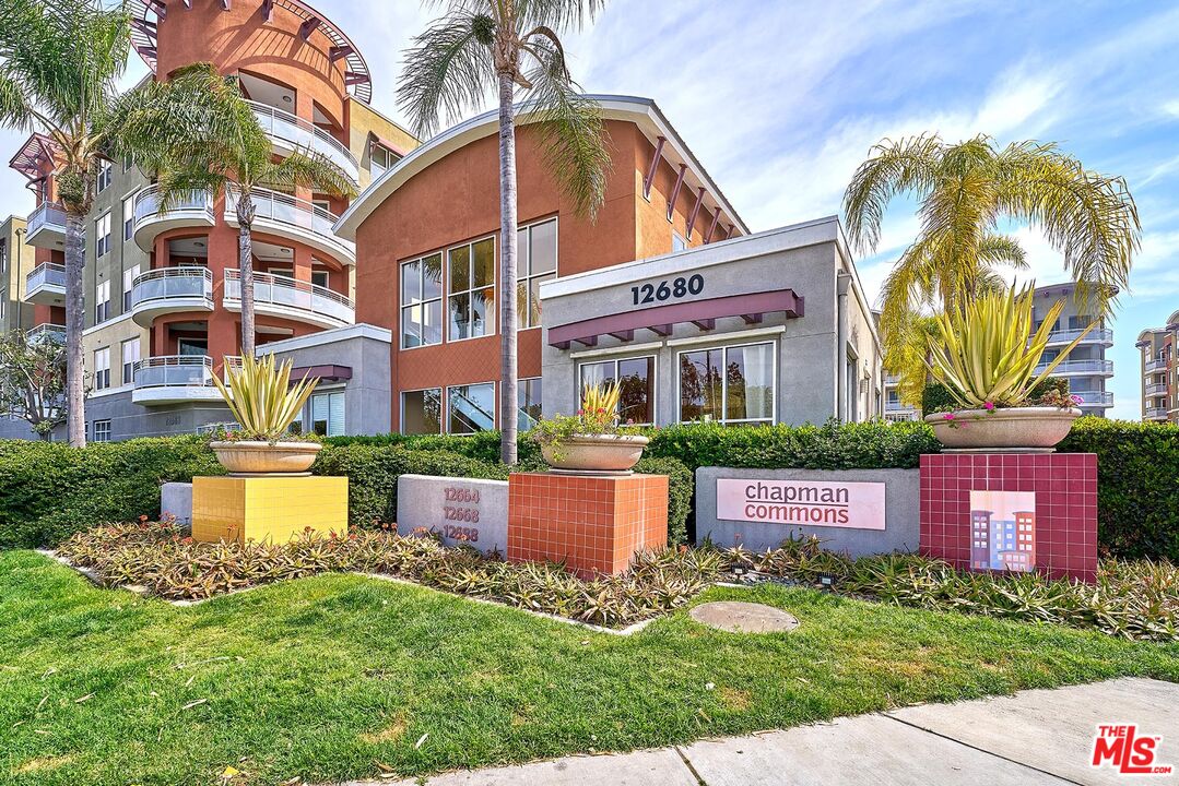 12664 Chapman Avenue, Unit 1208 Garden Grove, CA 92840 - Photo 28 of 29 a view of a house with a yard and plants