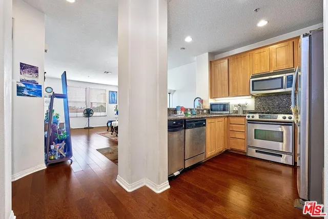 a kitchen with sink cabinets and wooden floor