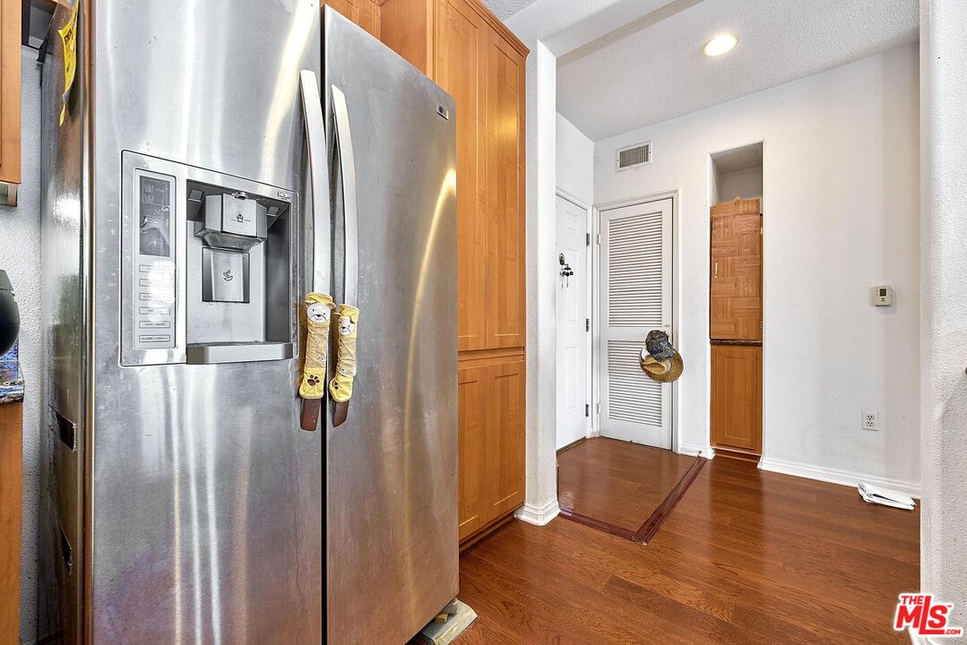 12664 Chapman Avenue, Unit 1208 Garden Grove, CA 92840 - Photo 7 of 29 a view of an empty room with wooden floor and a bathroom