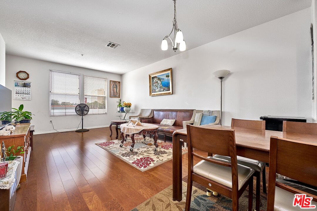 12664 Chapman Avenue, Unit 1208 Garden Grove, CA 92840 - Photo 8 of 29 a living room with fireplace furniture and a wooden floor