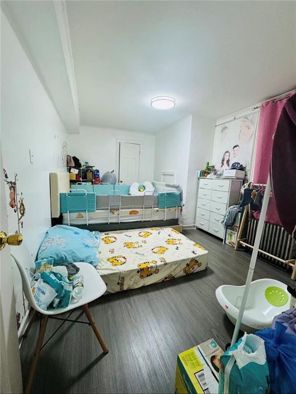 1253 70th Street Brooklyn, NY 11228 - Photo 12 of 13 a living room with furniture and wooden floor