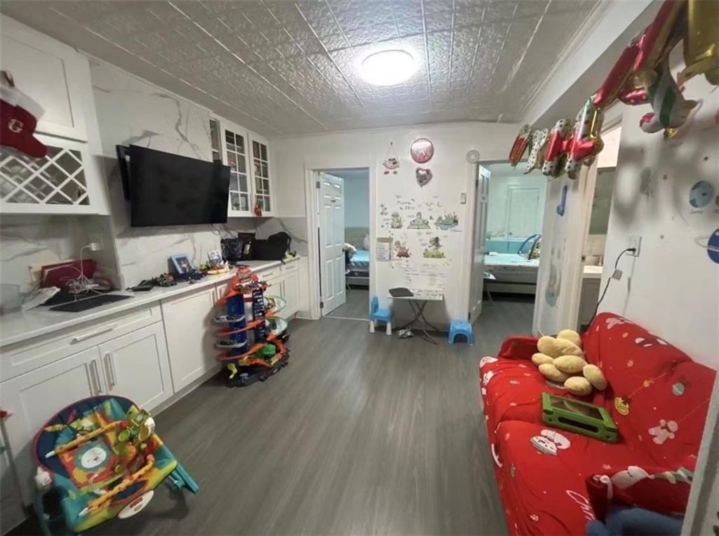 1253 70th Street Brooklyn, NY 11228 - Photo 6 of 13 a playing room with toys and a flat screen tv