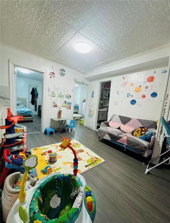 1253 70th Street Brooklyn, NY 11228 - Photo 7 of 13 a playing room with toys and a wooden floor