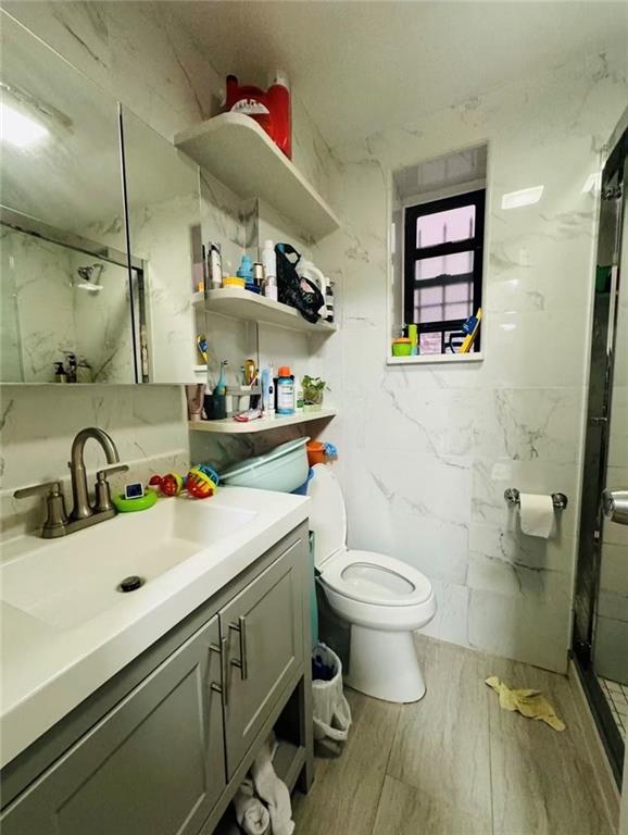 1253 70th Street Brooklyn, NY 11228 - Photo 10 of 13 a bathroom with a sink toilet and a mirror