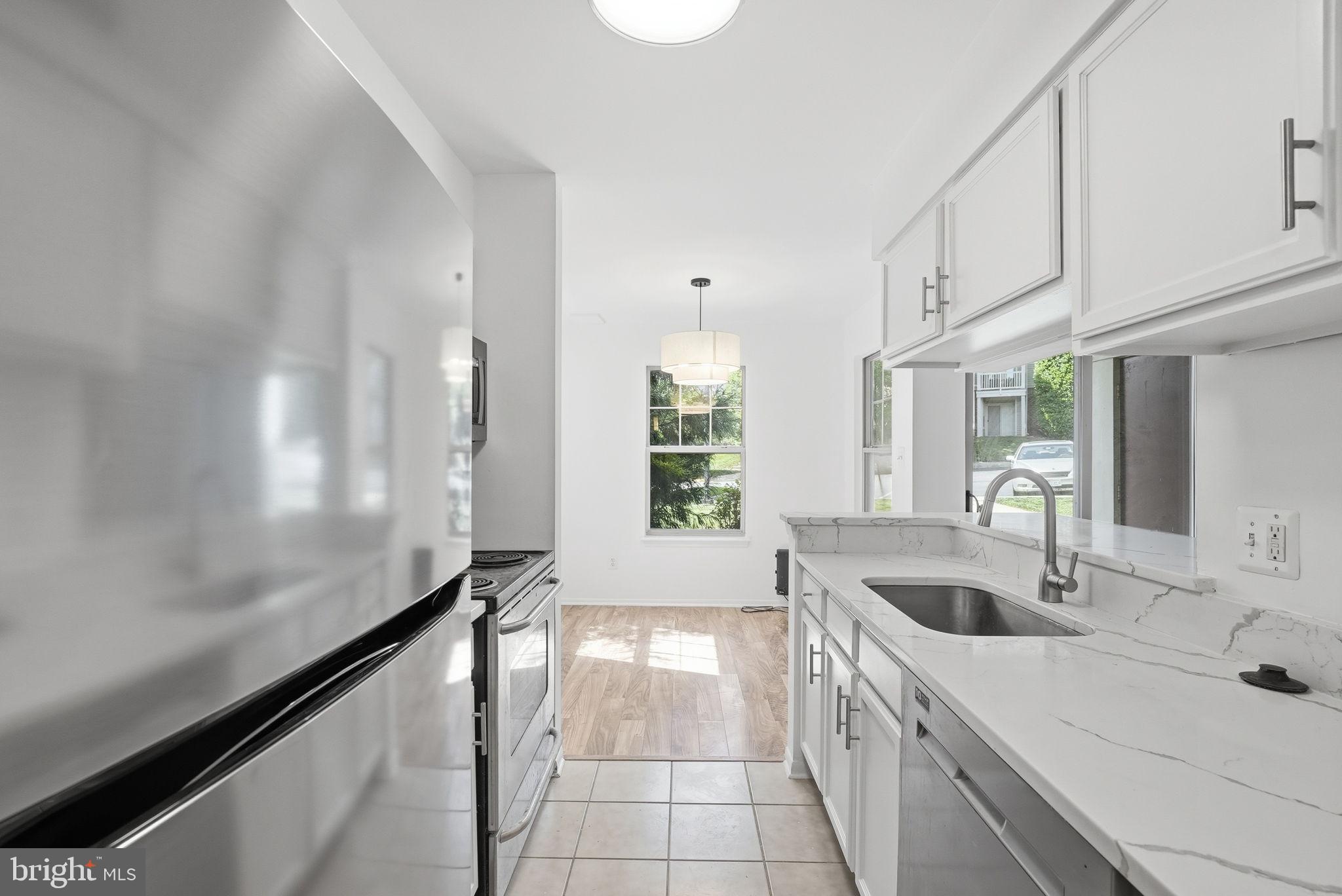 1703 Ascot Way, Unit D Reston, VA 20190 - Photo 9 of 21 a kitchen with a sink and cabinets