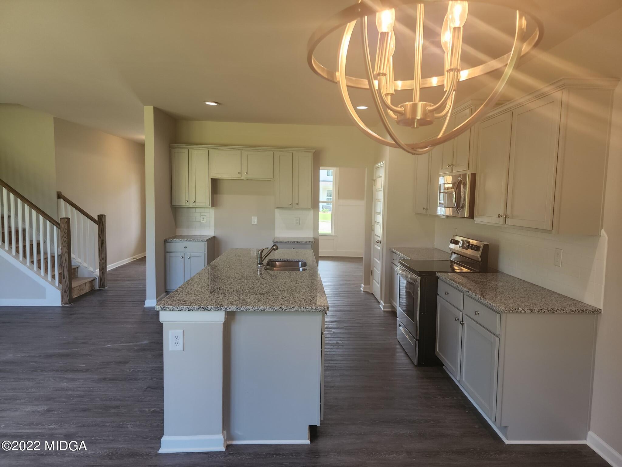 266 Presidents Way Forsyth, GA 31029 - Photo 2 of 21 a kitchen with stainless steel appliances granite countertop a sink a counter space and cabinets
