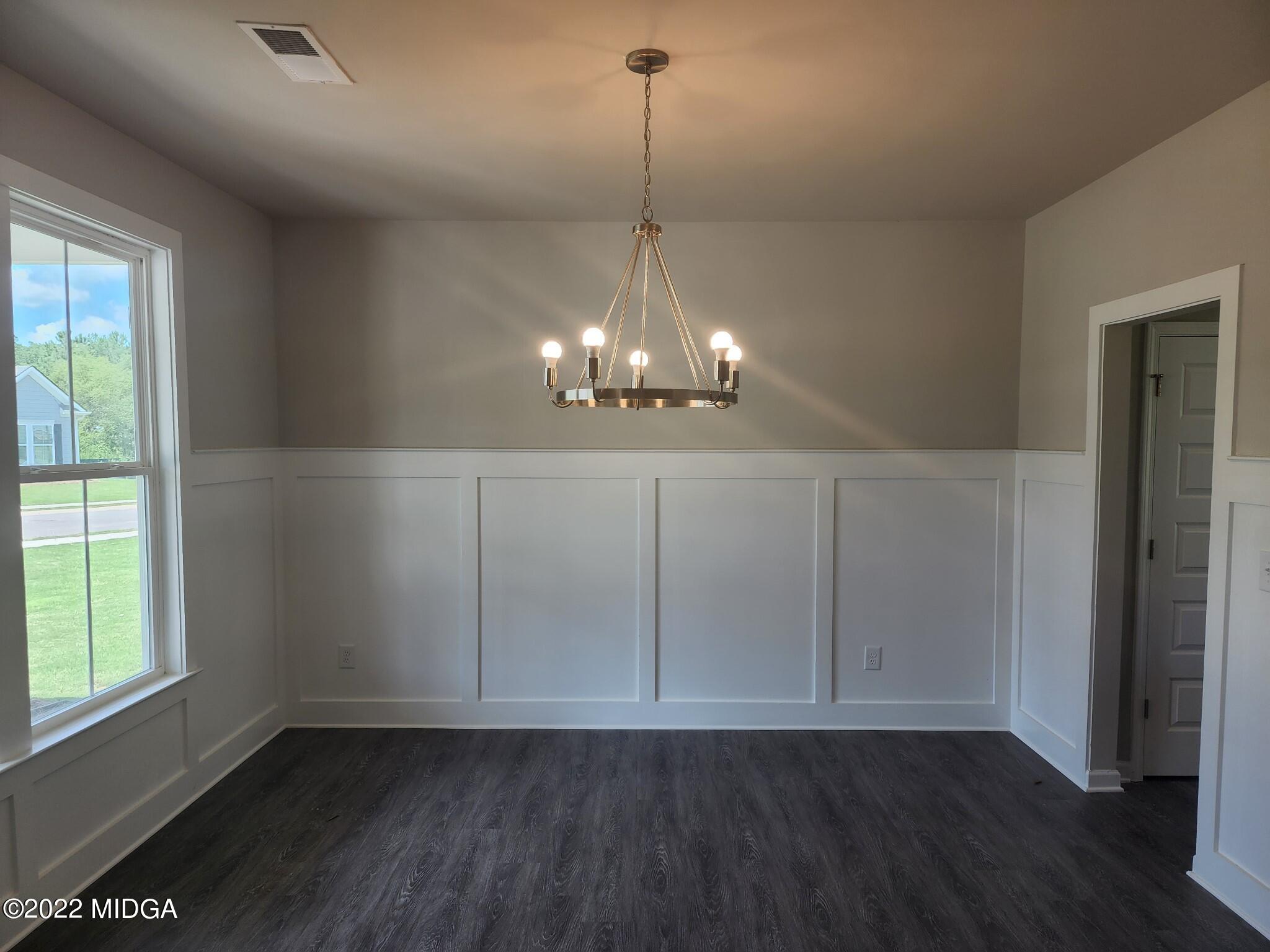 266 Presidents Way Forsyth, GA 31029 - Photo 4 of 21 a view of a room with wooden floor chandelier and window