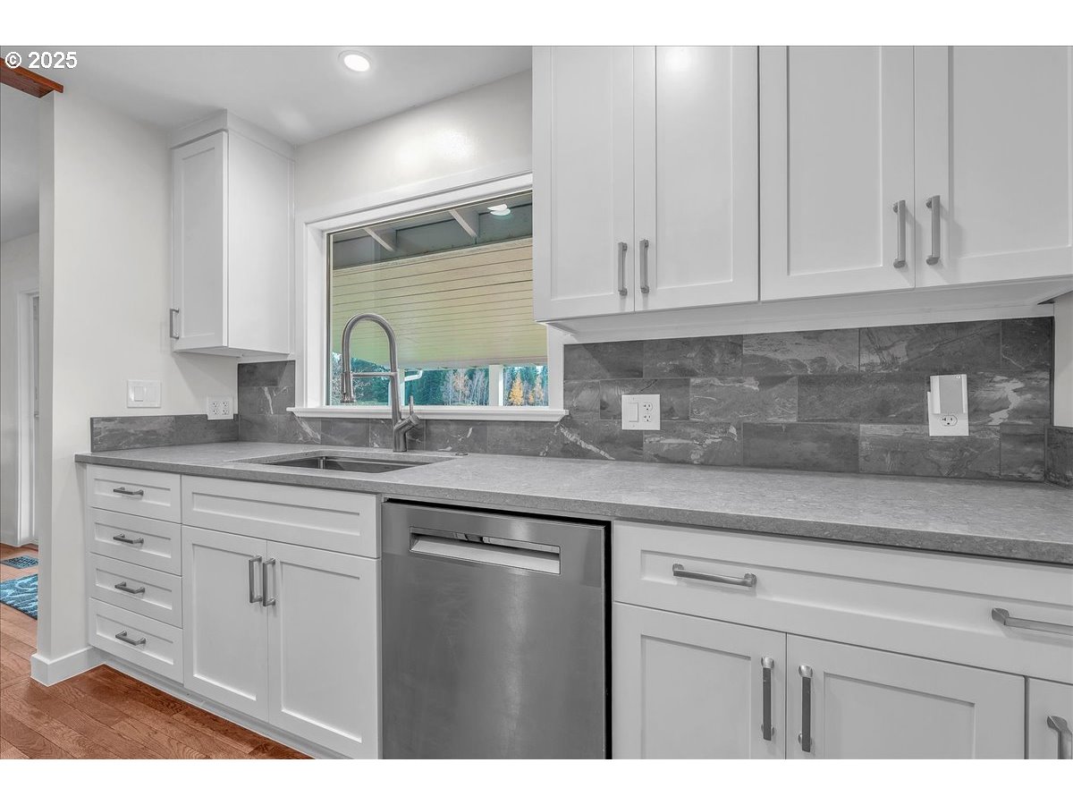 19448 Southwest Scholls Ferry Road Beaverton, OR 97007 - Photo 14 of 45 a kitchen with granite countertop white cabinets white appliances and a sink