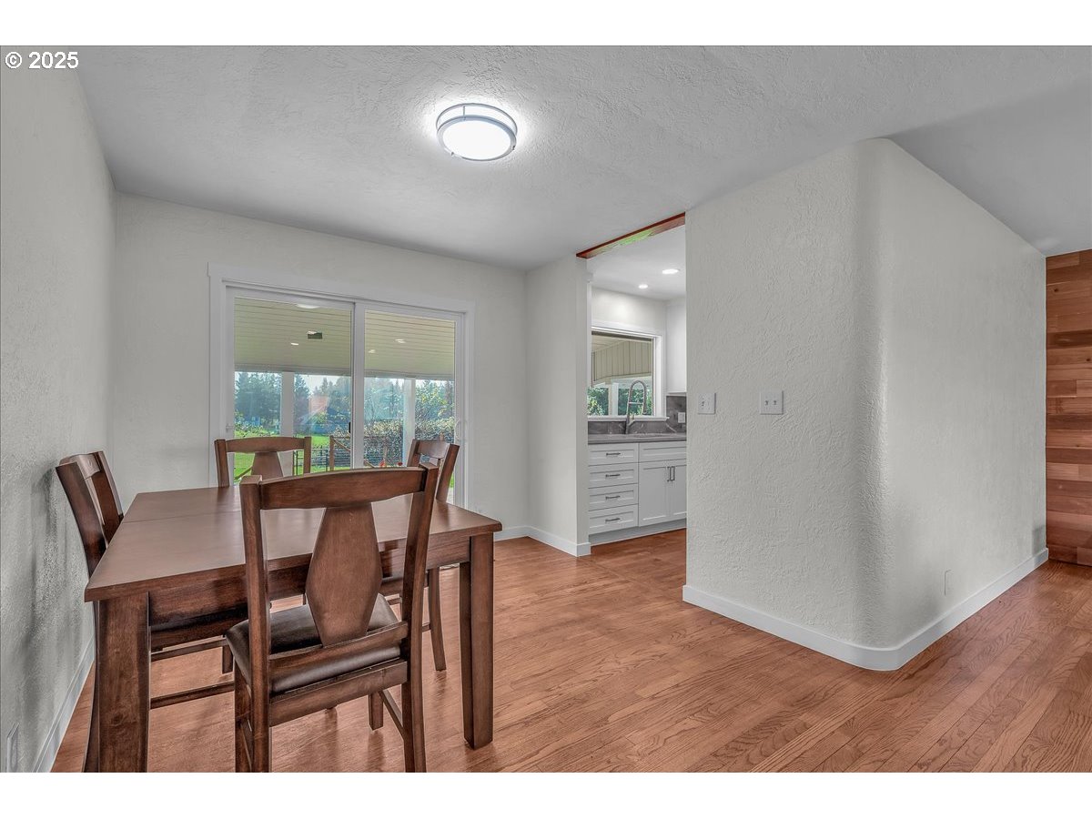 19448 Southwest Scholls Ferry Road Beaverton, OR 97007 - Photo 15 of 45 a view of a dining room with furniture and wooden floor