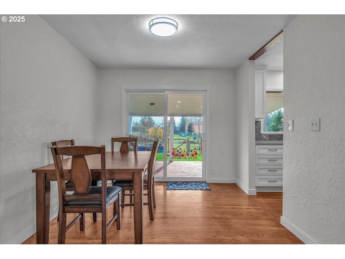 19448 Southwest Scholls Ferry Road Beaverton, OR 97007 - Photo 16 of 45 a view of a dining room with furniture and wooden floor