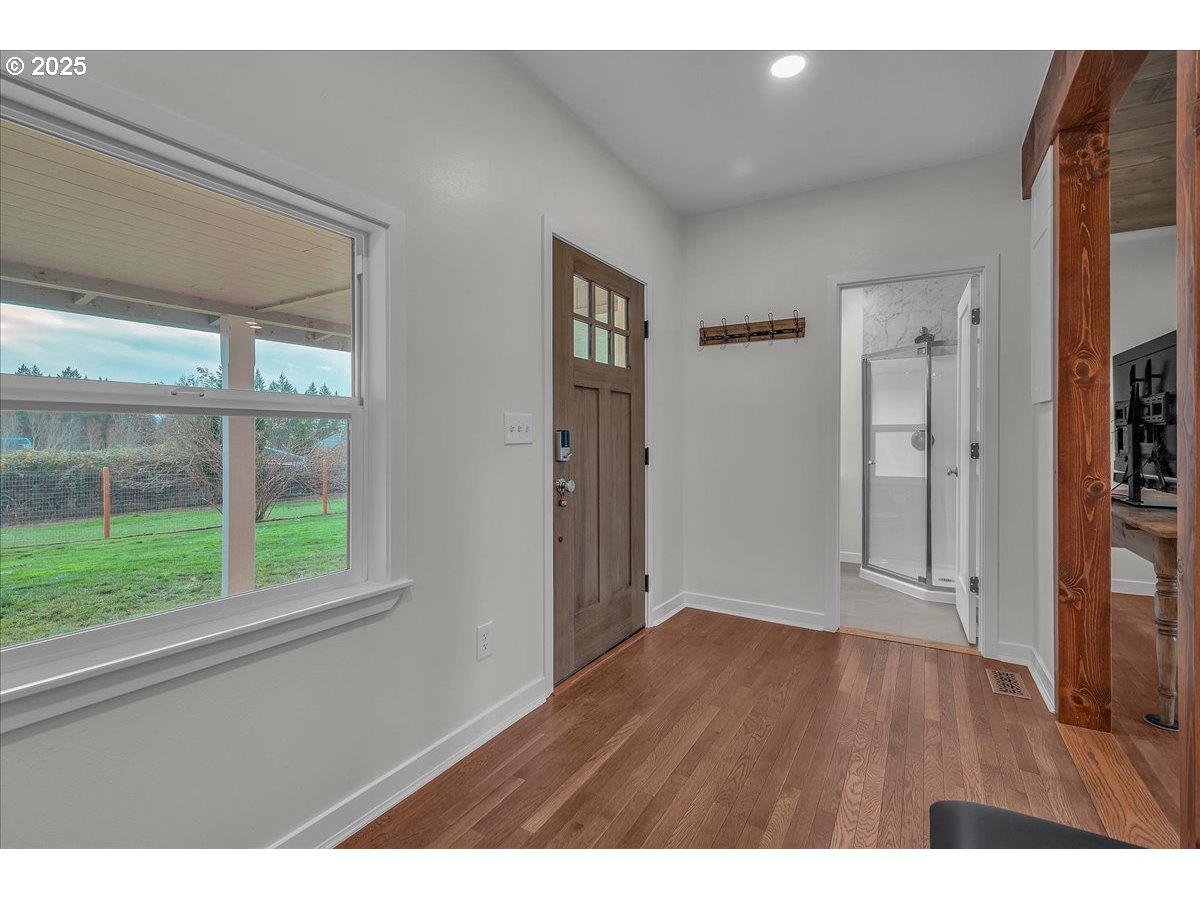 19448 Southwest Scholls Ferry Road Beaverton, OR 97007 - Photo 21 of 45 a view of an empty room with wooden floor and a window