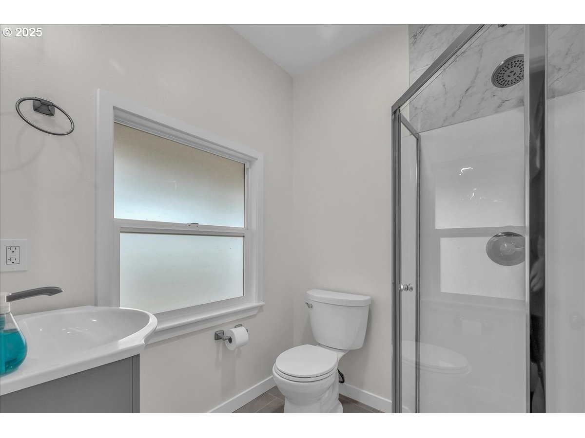 19448 Southwest Scholls Ferry Road Beaverton, OR 97007 - Photo 22 of 45 a bathroom with a toilet a sink and mirror