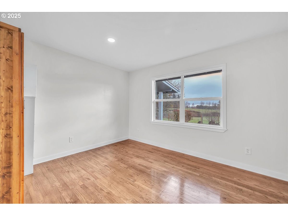 19448 Southwest Scholls Ferry Road Beaverton, OR 97007 - Photo 24 of 45 an empty room with wooden floor and windows