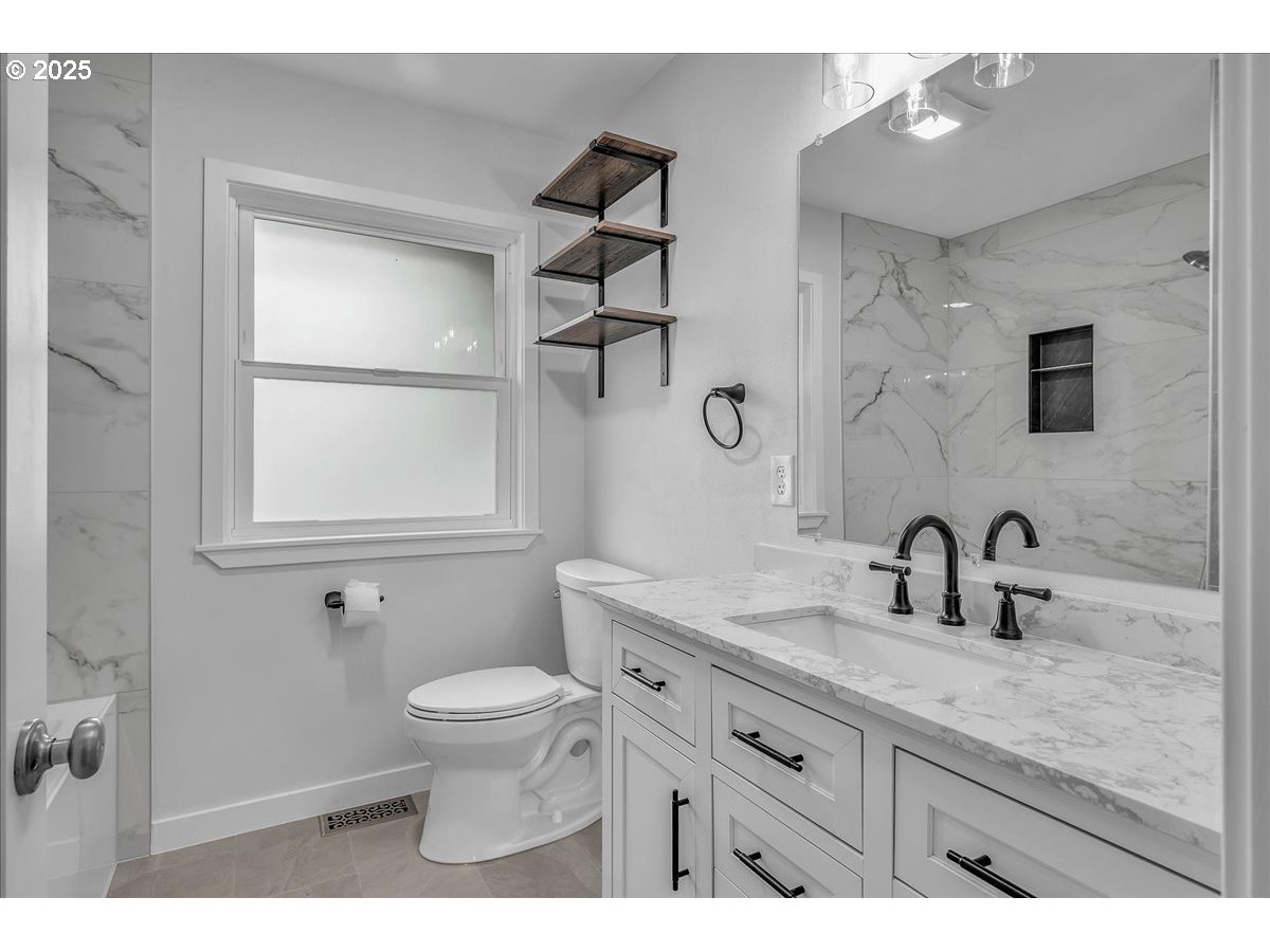 19448 Southwest Scholls Ferry Road Beaverton, OR 97007 - Photo 25 of 45 a bathroom with a granite countertop sink a toilet and a mirror