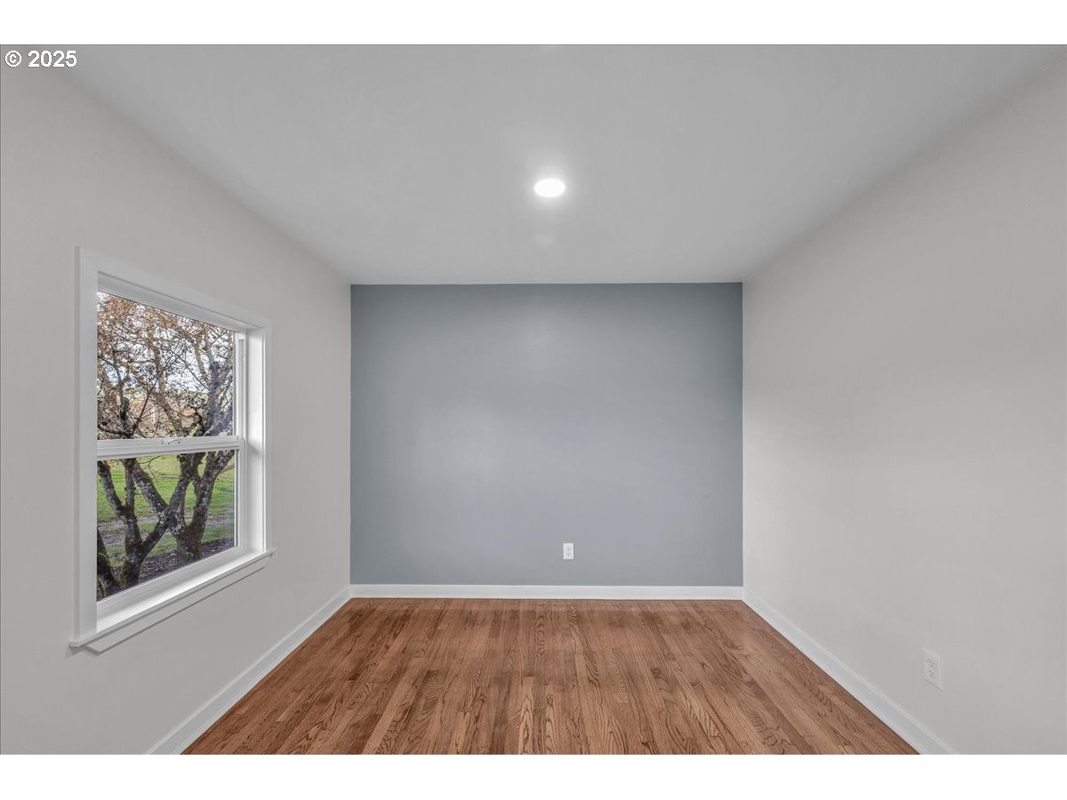 19448 Southwest Scholls Ferry Road Beaverton, OR 97007 - Photo 27 of 45 a view of an empty room with wooden floor and a window