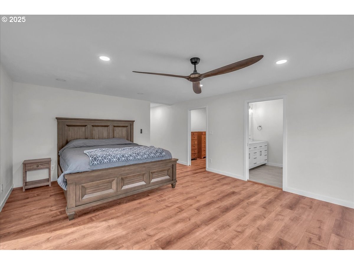 19448 Southwest Scholls Ferry Road Beaverton, OR 97007 - Photo 30 of 45 a bedroom with a large bed and a chandelier