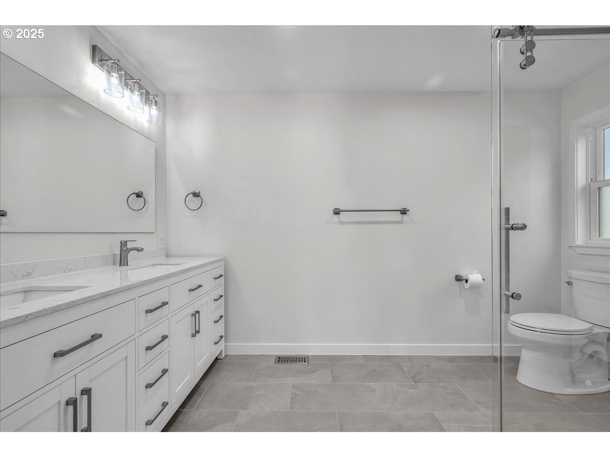 19448 Southwest Scholls Ferry Road Beaverton, OR 97007 - Photo 36 of 45 a bathroom with a granite countertop sink a toilet and a mirror
