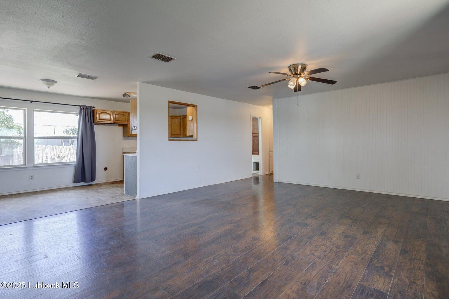 3506 Elm Avenue Lubbock, TX 79404 - Photo 5 of 12 wooden floor in an empty room with a window