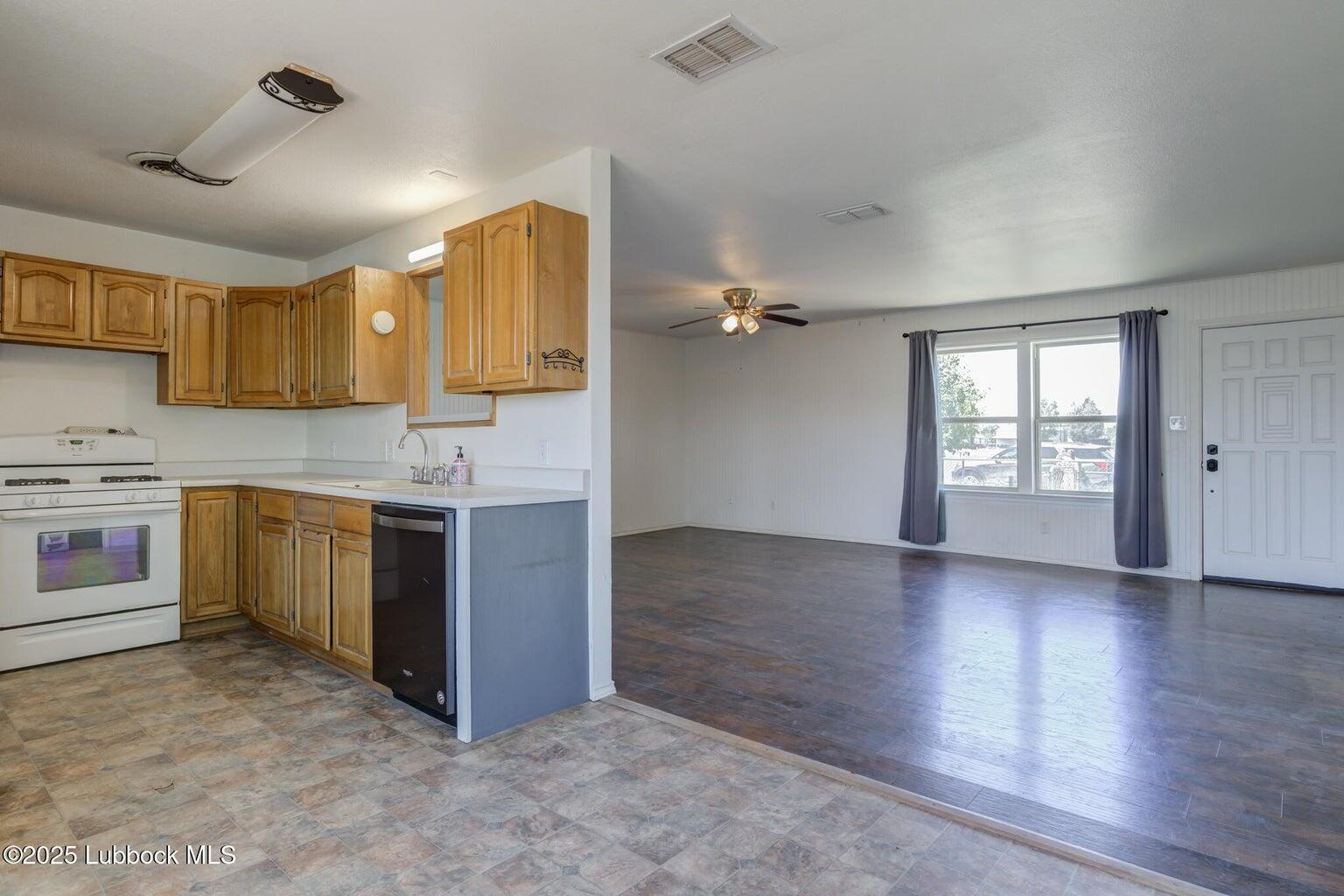 3506 Elm Avenue Lubbock, TX 79404 - Photo 8 of 12 a kitchen with a stove sink and cabinets