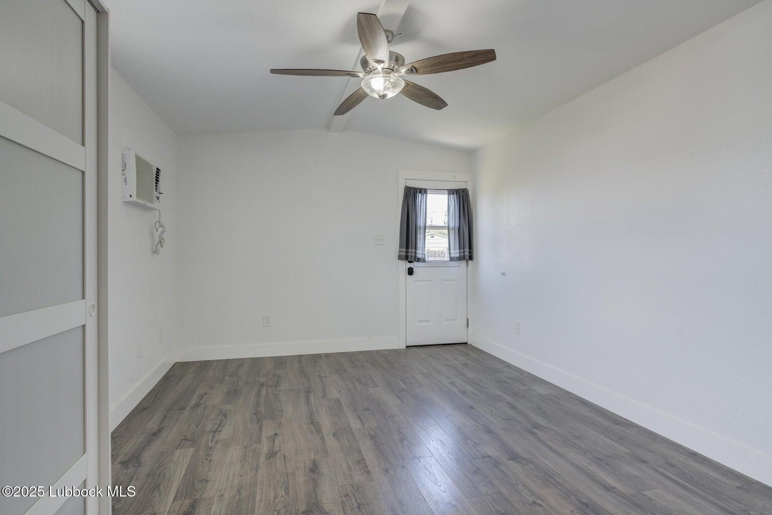 3506 Elm Avenue Lubbock, TX 79404 - Photo 10 of 12 wooden floor in an empty room with a window