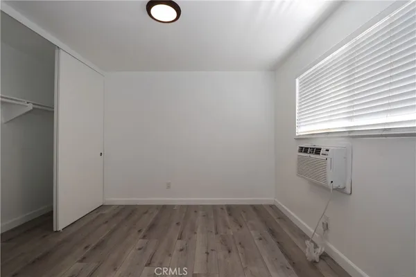 a view of a room with wooden floor and window