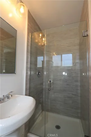 a bathroom with a shower and a sink