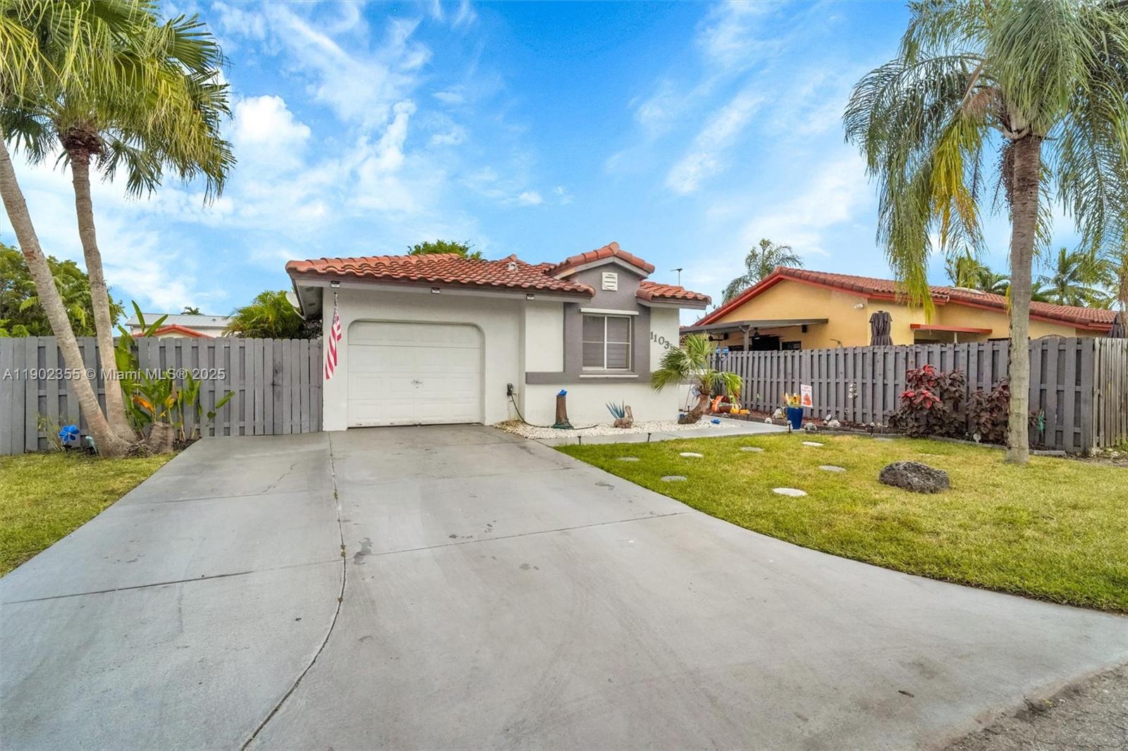 a view of a house with a yard and palm trees