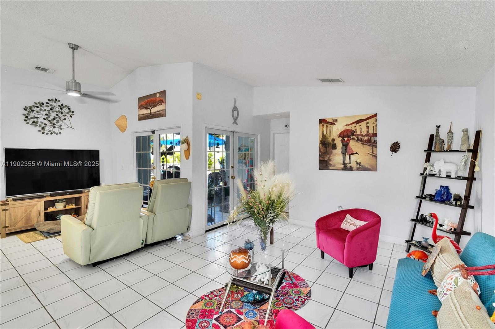 11035 Southwest 148th Place Miami, FL 33196 - Photo 11 of 48 a living room with furniture and a flat screen tv