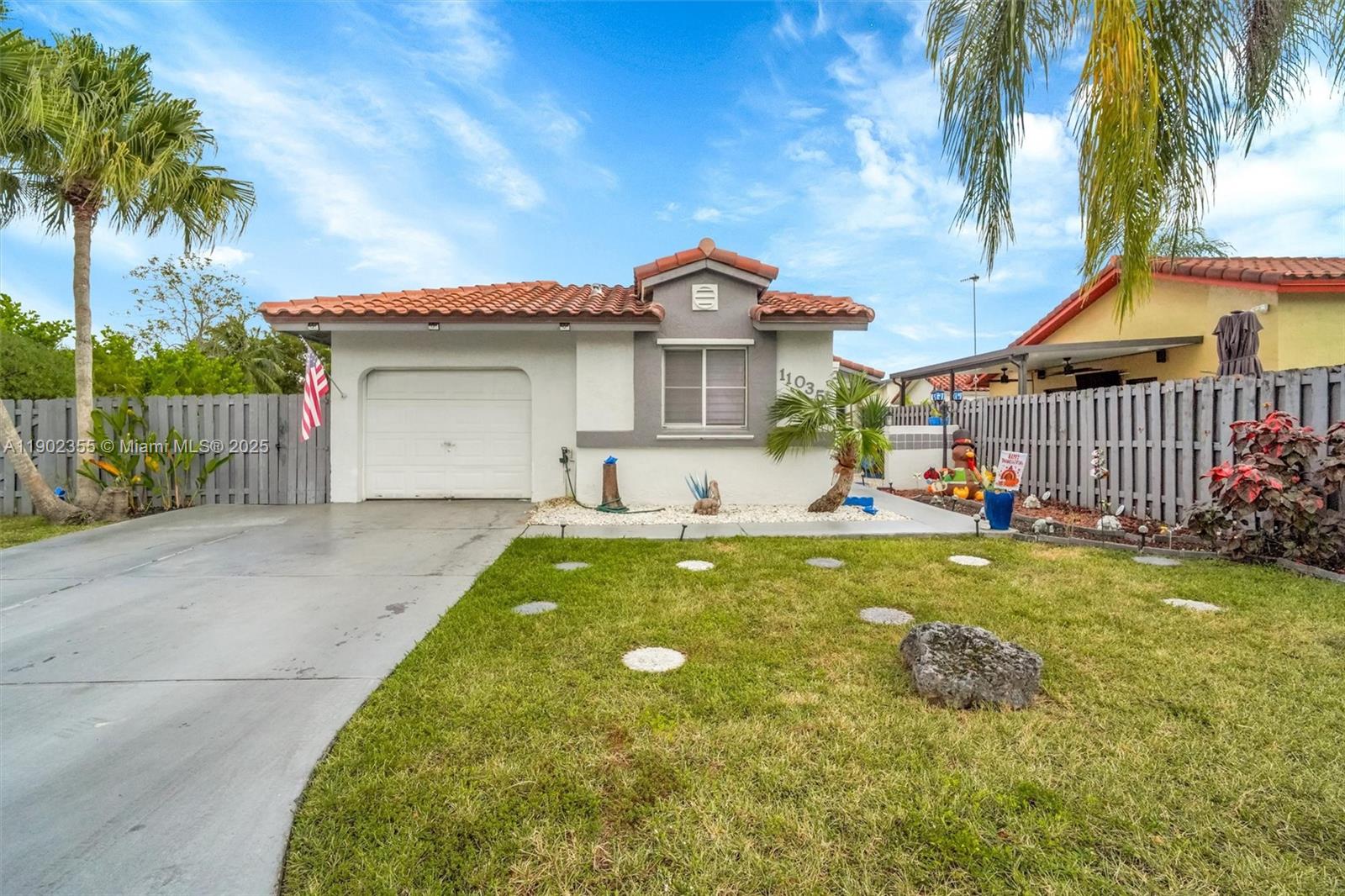 11035 Southwest 148th Place Miami, FL 33196 - Photo 2 of 48 a view of a house with a yard and a palm tree