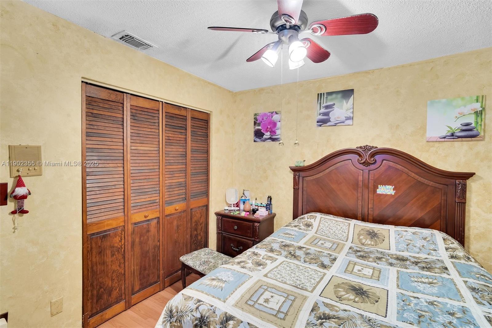 11035 Southwest 148th Place Miami, FL 33196 - Photo 30 of 48 a bedroom with a bed and a chandelier