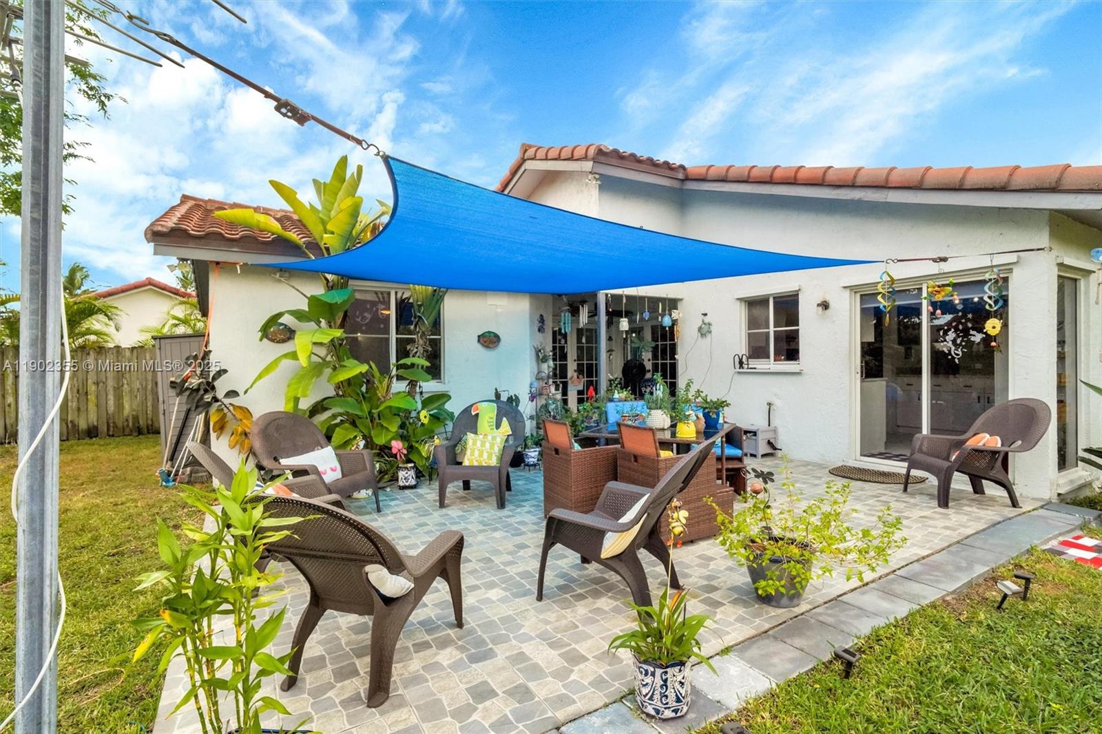 11035 Southwest 148th Place Miami, FL 33196 - Photo 37 of 48 a view of a patio with a table and chairs under an umbrella