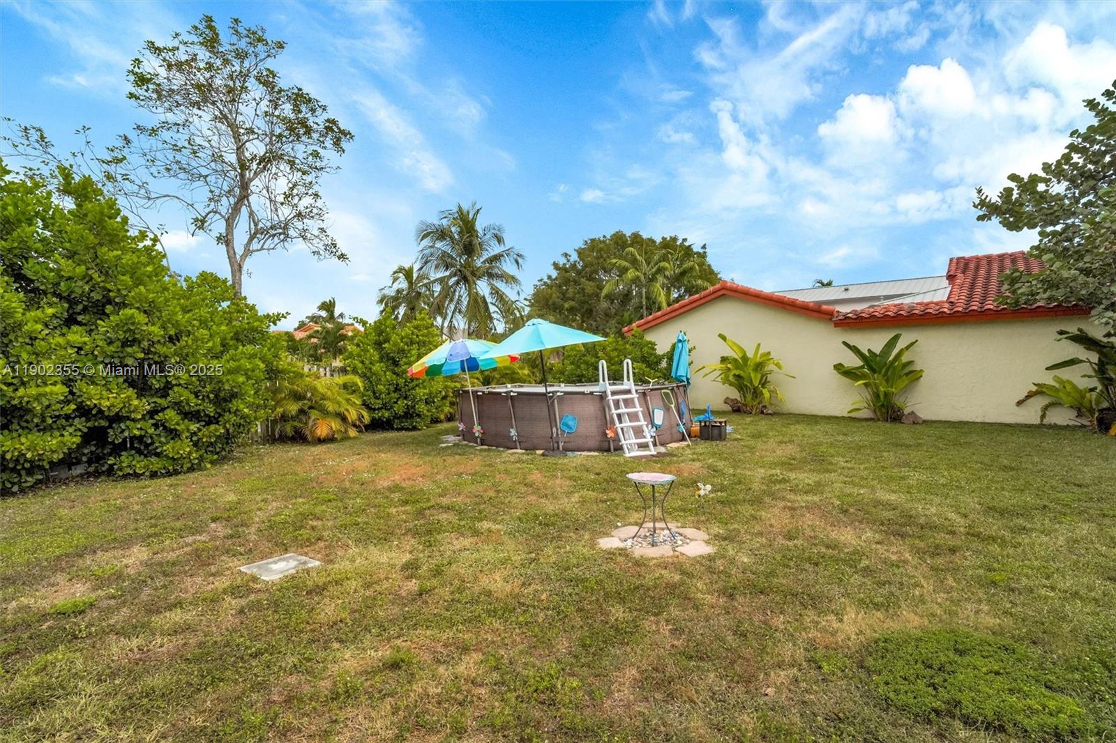 11035 Southwest 148th Place Miami, FL 33196 - Photo 47 of 48 a view of a house with a yard and garage