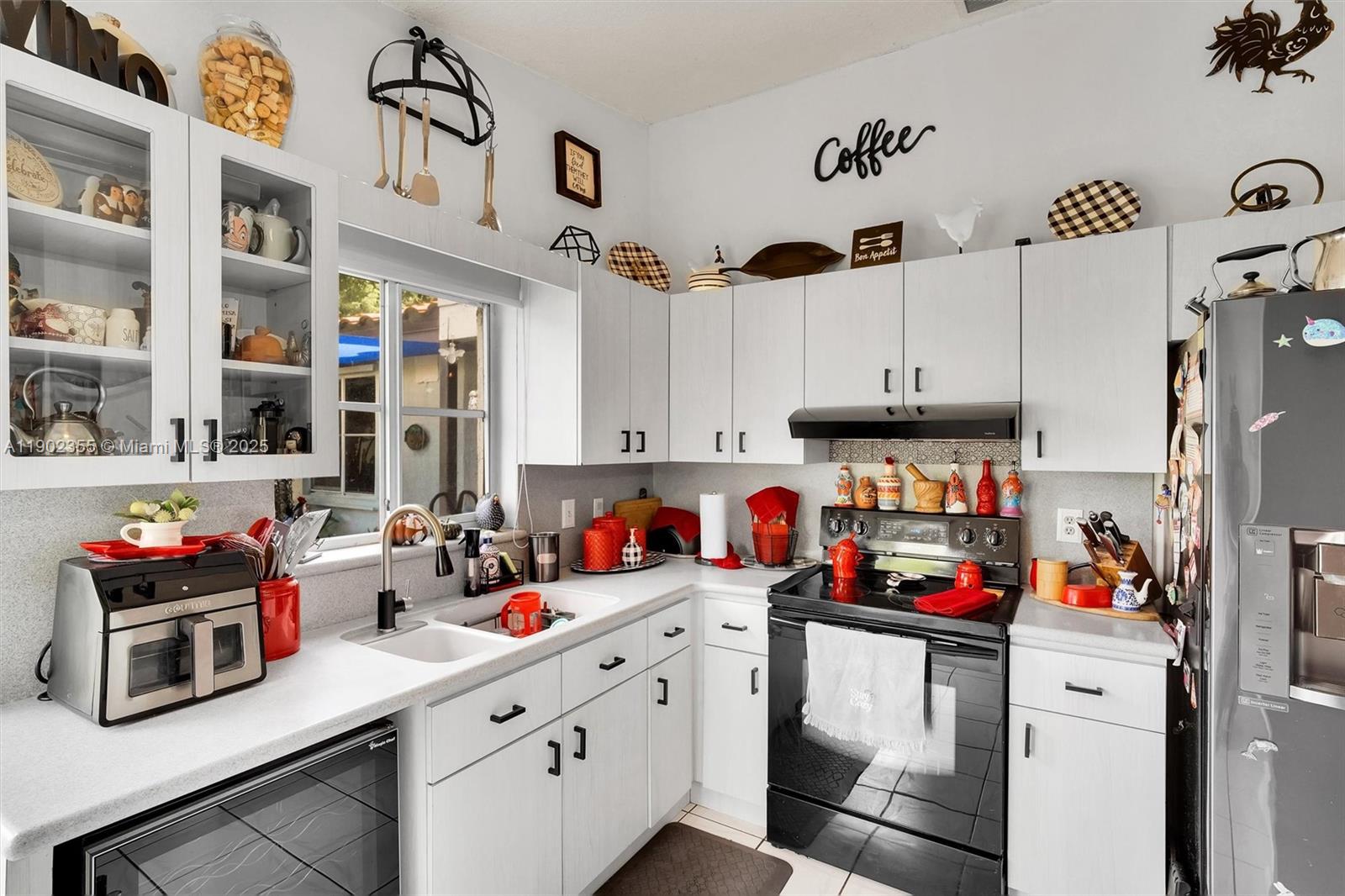 11035 Southwest 148th Place Miami, FL 33196 - Photo 10 of 48 a kitchen with lots of counter top space and cabinets