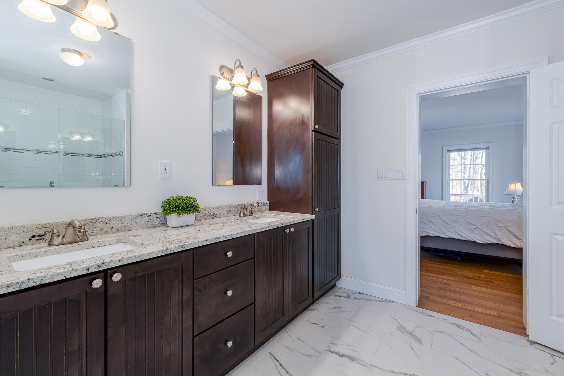 151 Tonset Road Orleans, MA 02653 - Photo 22 of 44 a en suite bathroom with a granite countertop sink and a mirror