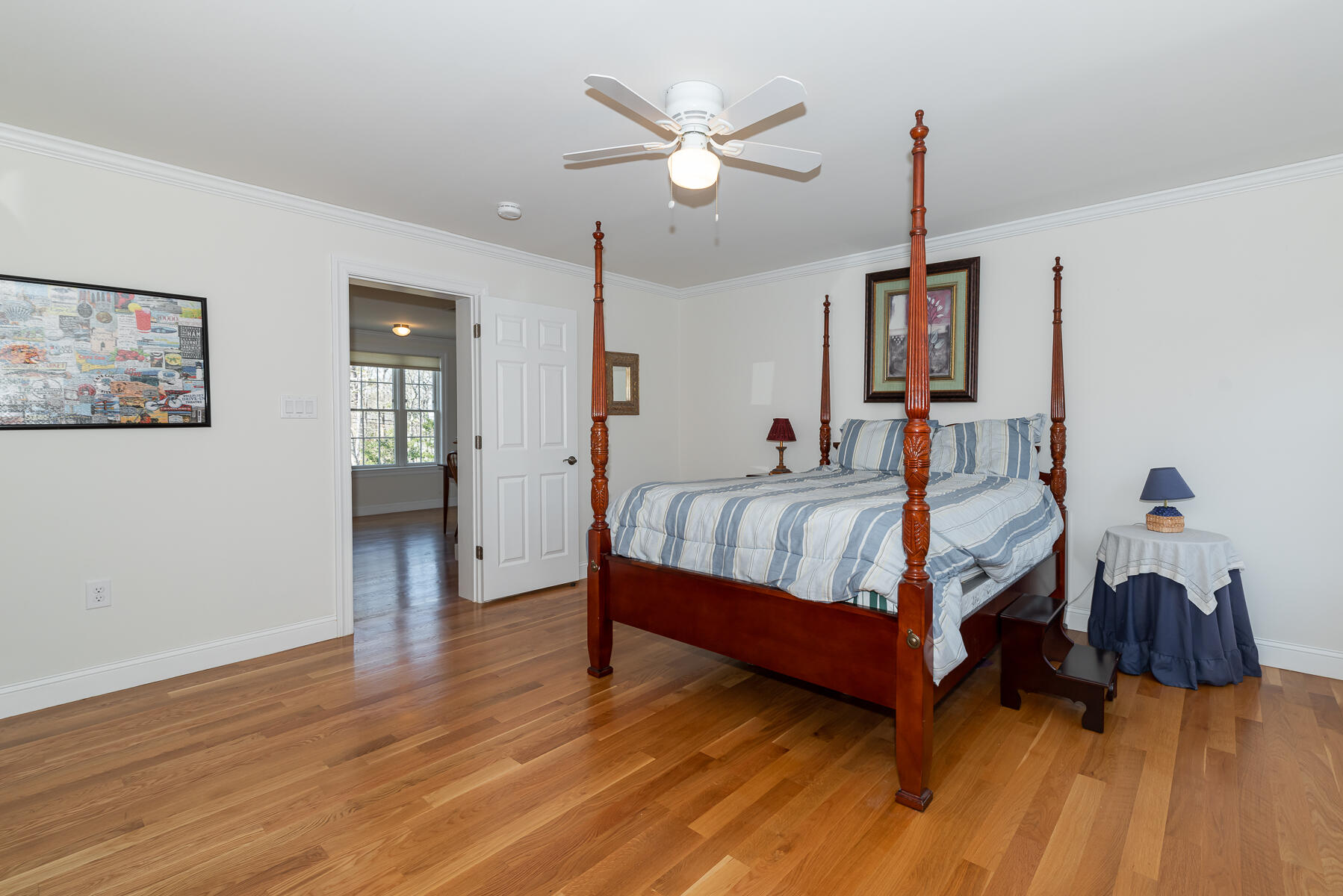 151 Tonset Road Orleans, MA 02653 - Photo 32 of 44 a bedroom with a bed and a chandelier