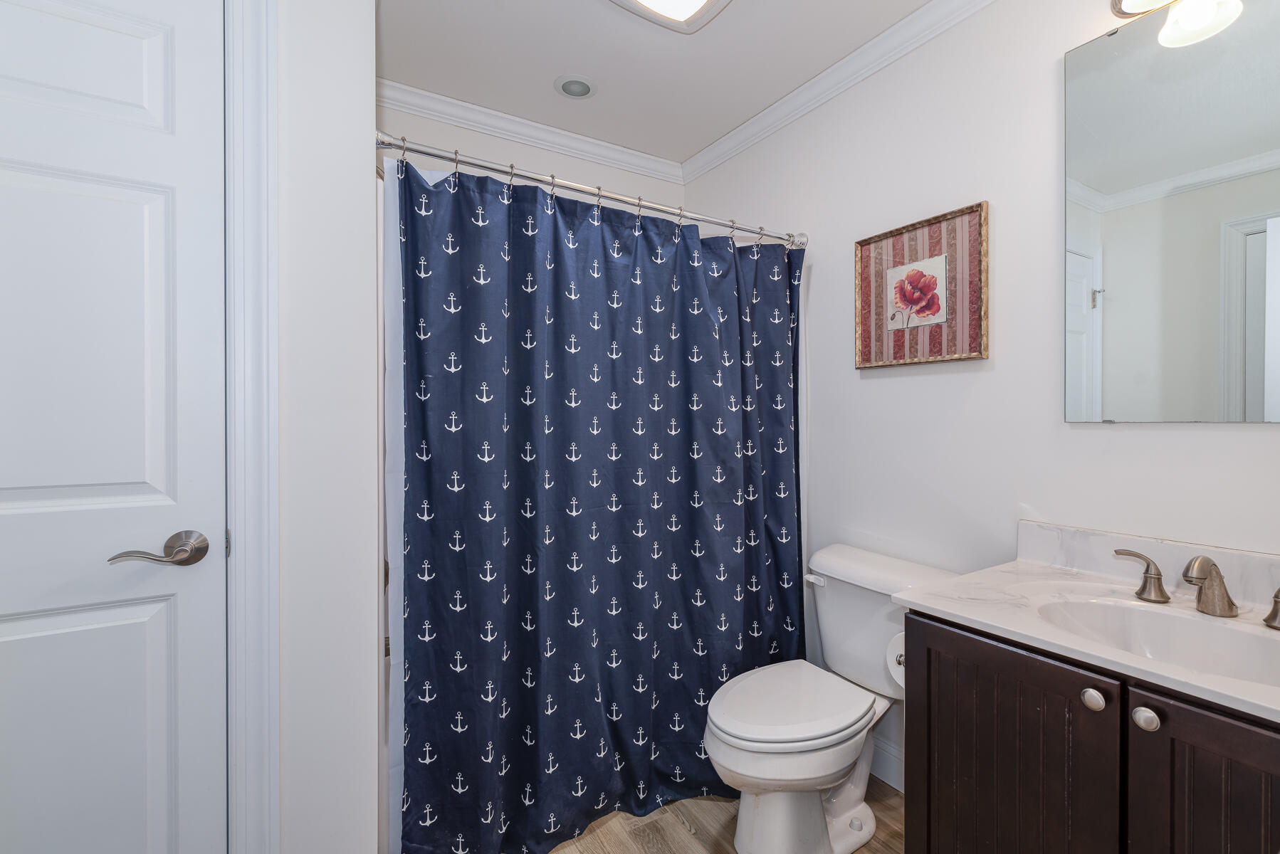 151 Tonset Road Orleans, MA 02653 - Photo 33 of 44 a white toilet sitting next to a bathroom sink