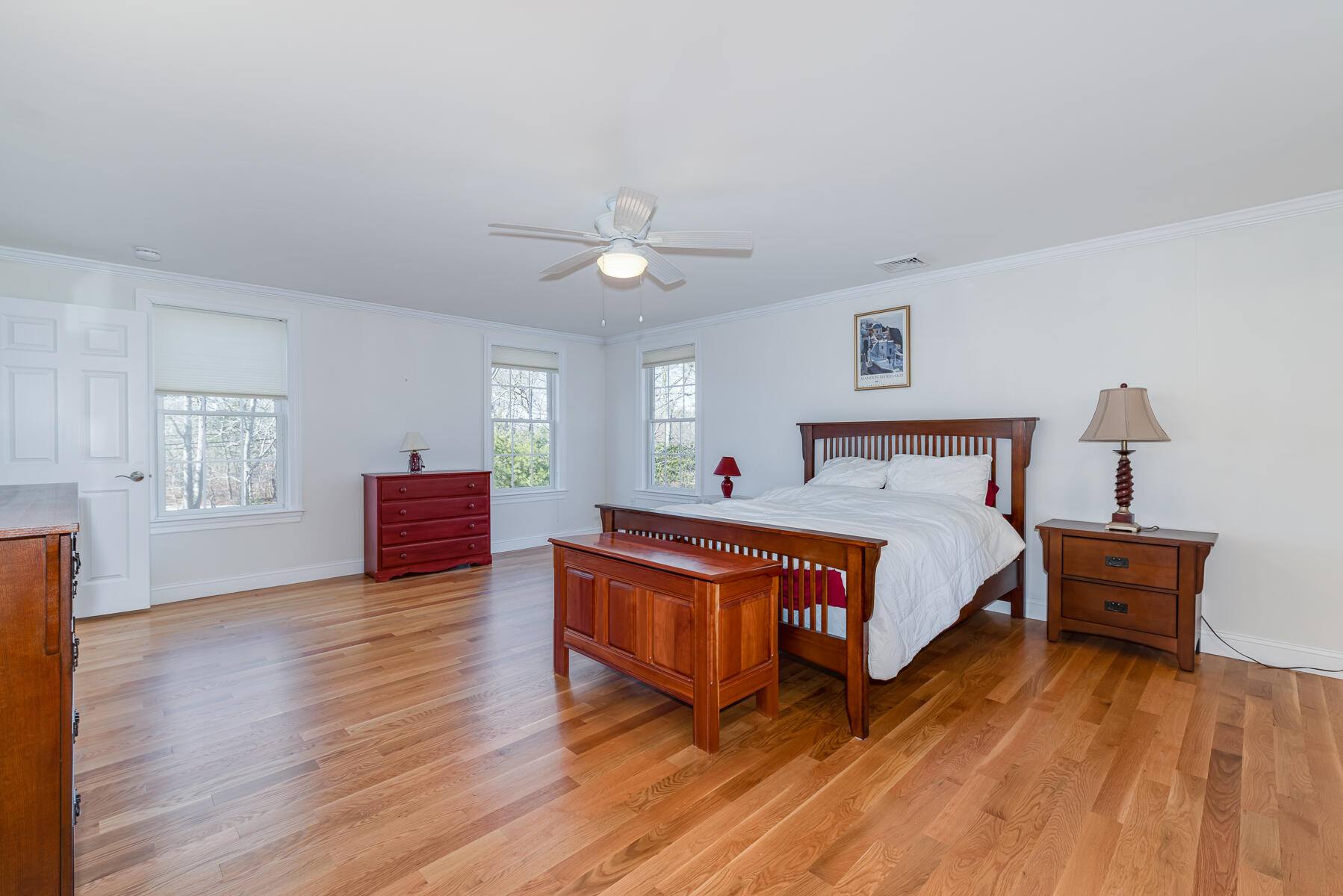 151 Tonset Road Orleans, MA 02653 - Photo 34 of 44 a bedroom with a bed and wooden floor