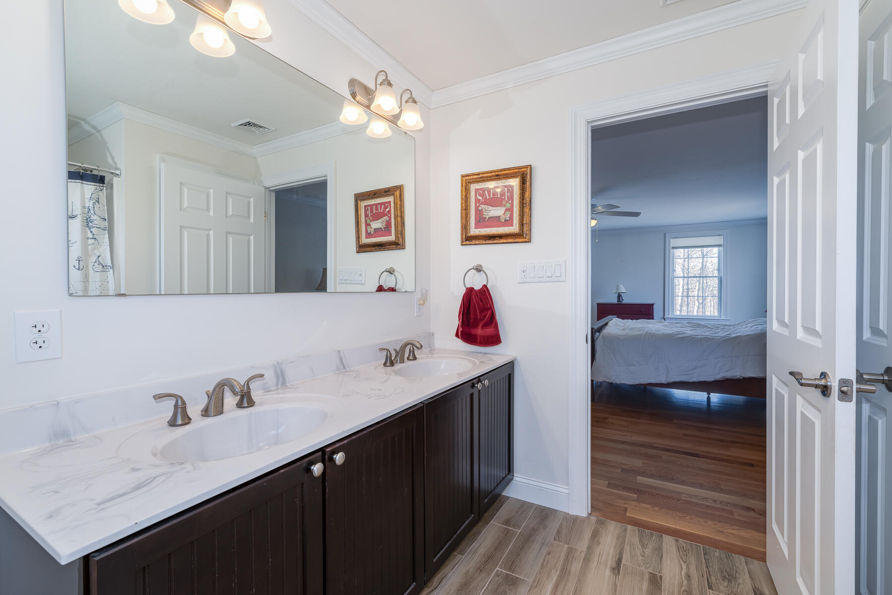 151 Tonset Road Orleans, MA 02653 - Photo 36 of 44 a en suite bathroom with a sink and a mirror