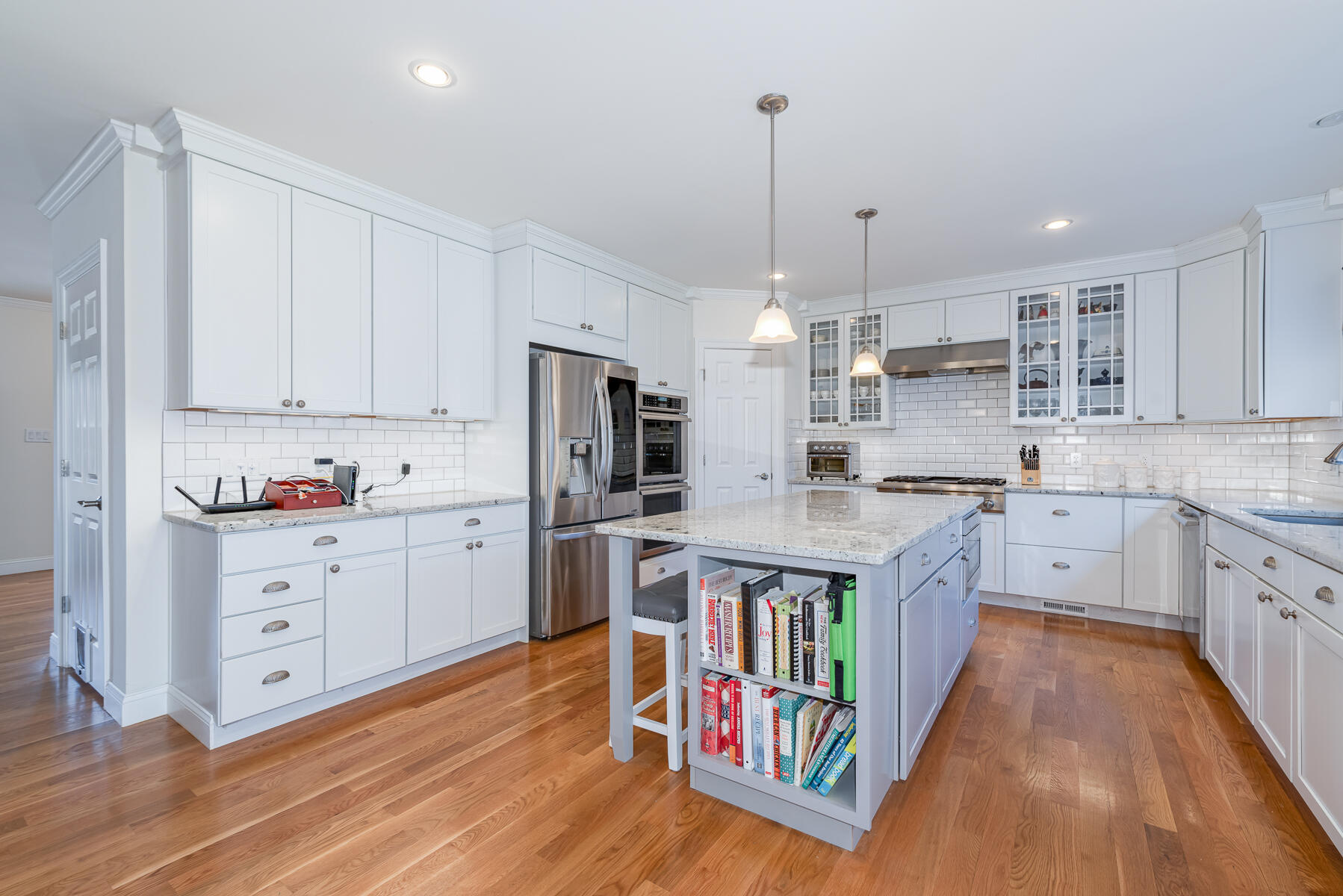 151 Tonset Road Orleans, MA 02653 - Photo 5 of 44 a kitchen with stainless steel appliances kitchen island granite countertop a stove a sink dishwasher a refrigerator and white cabinets with wooden floor