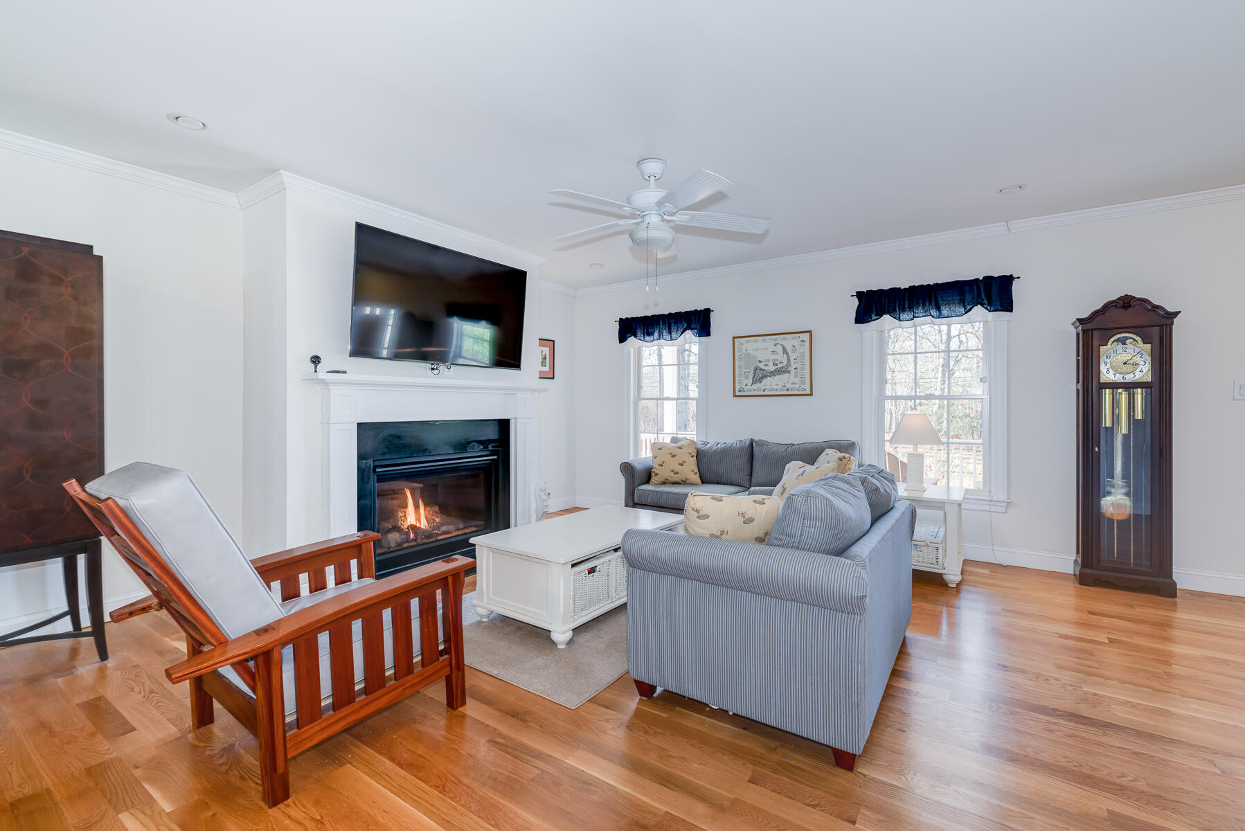 151 Tonset Road Orleans, MA 02653 - Photo 10 of 44 a living room with furniture a flat screen tv and a fireplace