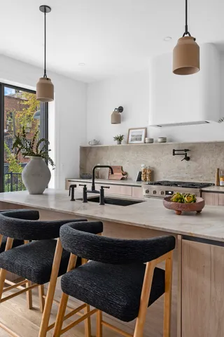 a kitchen with a stove a sink and a chandelier