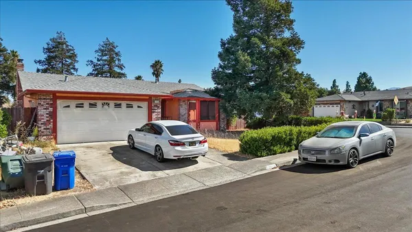 a view of a car parked in front of a house