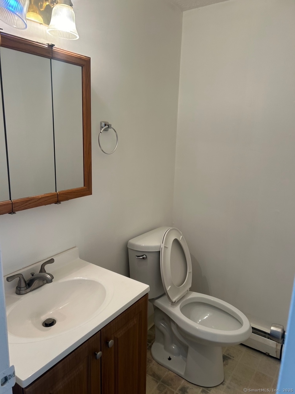 126 Sutton Place, Unit 126 Bloomfield, CT 06002 - Photo 3 of 8 a bathroom with a toilet sink and mirror