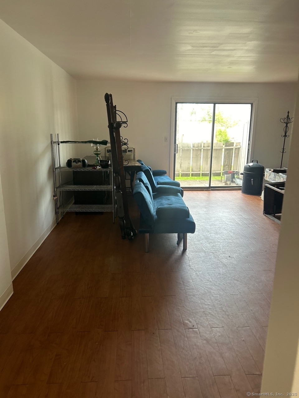 126 Sutton Place, Unit 126 Bloomfield, CT 06002 - Photo 8 of 8 a living room with furniture and a floor to ceiling window