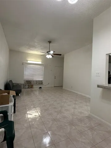 a view of a livingroom with furniture and chandelier fan