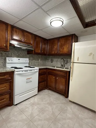 a kitchen with a stove sink and a refrigerator